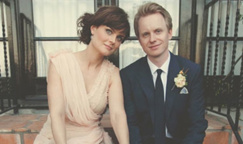 Emily Deschanel wearing cream brown and David Hornsby on his Tuxedo on their marriage 